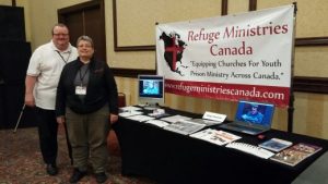 Alan and Sharon Campbell with ”Refuge Ministries Canada” ministry display table at the “Apostolic Church of Pentecost “ national conference in Toronto,Ontario.